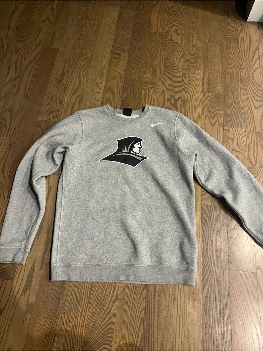 Nike crewneck sweatshirt featuring white logo of the  providence Friars